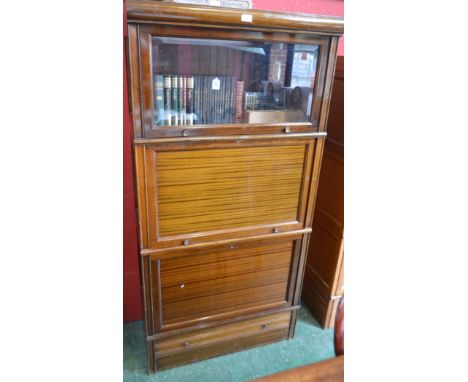 A Globe Wernicke type bookcase, rectangular top above two horizontally hinged and retractable doors, the upper glazed, a fall