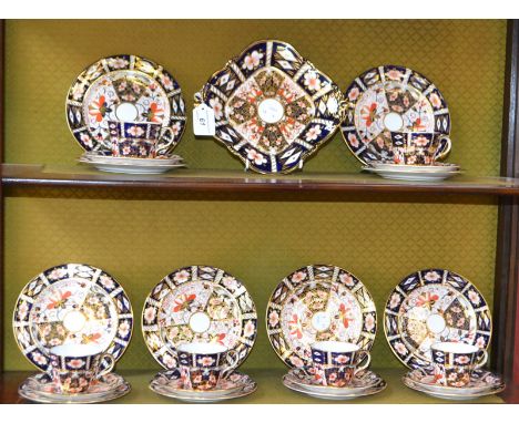 A Royal Crown Derby 2451 pattern part tea service comprising cups, saucers, side plates, cake plates; a lobed dish, acorn han