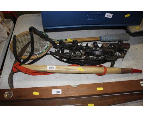 An ice axe; a pair of crampons; and two badminton rackets 
