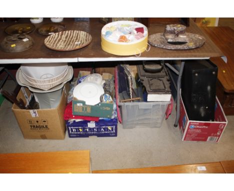 A large quantity of miscellaneous china, glass, textiles and books; a wall clock; a mahogany rack, lampshades etc.
