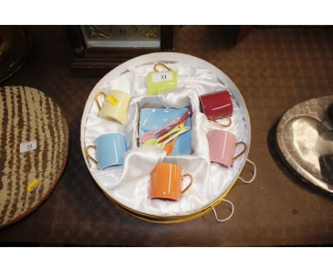 A set of Silea bone china coffee cans, saucers and spoons, in fitted silk lined box 