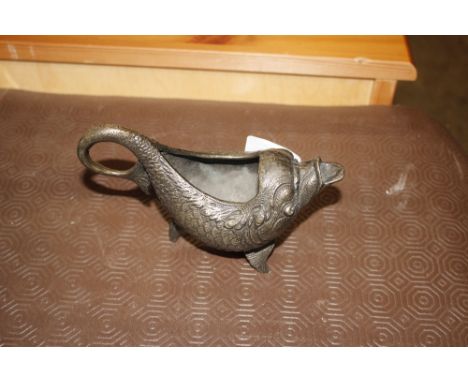 A Chinese bronze sauce boat in the form of a stylised dolphin
