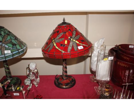 A red dragonfly decorated Tiffany style table lamp