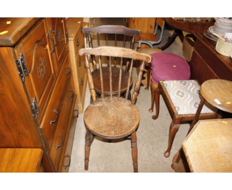 A pair of elm seated stick back kitchen chairs