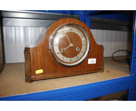 A 1930's walnut striking mantel clock