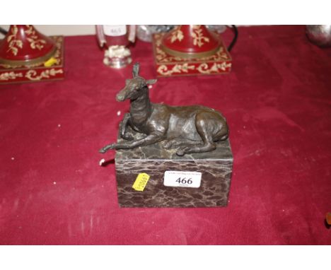 A bronze study of a recumbent deer