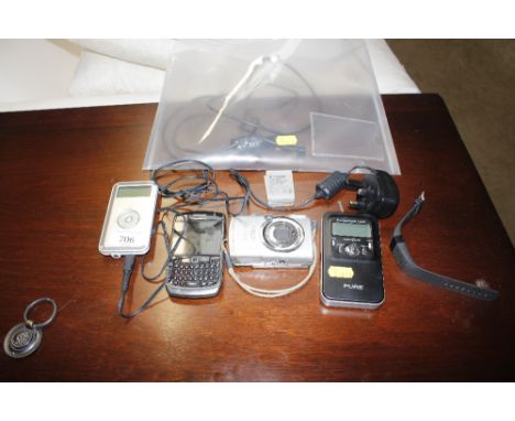 A Canon digital camera; a Blackberry phone; and various other items 