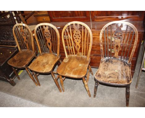 Four elm seated stick and wheel back dining chairs 