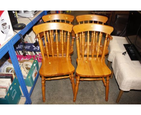 A set of four modern pine stick back kitchen chairs, two standards and two elbows 