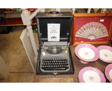 A Remington Rand portable typewriter and manual