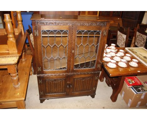 An Ercol linen fold and leaded glazed bookcase