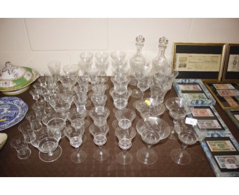 A suite of foliate etched glassware including a pair of decanters, Champagne saucers, wine glasses, sherry's, liqueurs, sunda