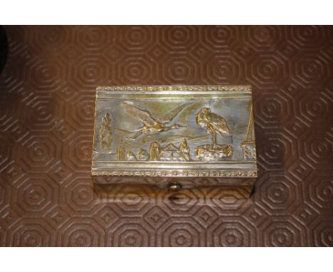 A Victorian silver plated jewellery box with a stork decorated lid and button down silk interior