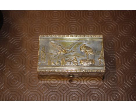 A Victorian silver plated jewellery box with a stork decorated lid and button down silk interior