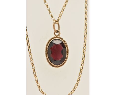 A 9CT GOLD GARNET PENDANT WITH CHAIN, the pendant of an oval form, in a milgrain collet set with a fine rope twist surround, 