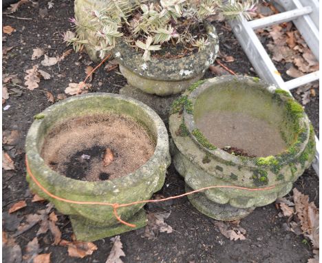 THREE WEATHERED COMPOSITE GARDEN PLANTERS, two with fluted blustered bowls, the other with rope and swag detail the, largest 