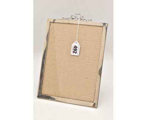 AN EDWARDIAN SILVER PHOTO FRAME, of a polished rectangular form with bow detail, hallmarked 'E Mander &amp; Son' Birmingham 1