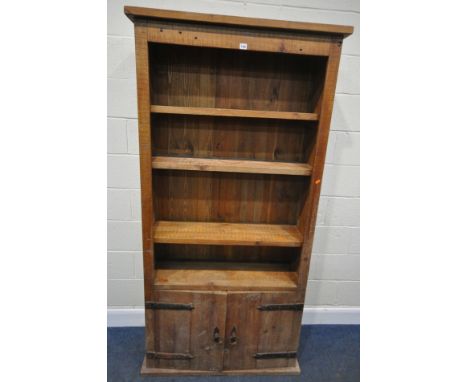 A HARDWOOD OPEN BOOKCASE, fitted with double cupboard doors, condition report: shelf pins previously glued into the holes, ma
