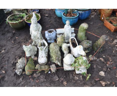 A  COLLECTION OF NINETEEN WEATHERED COMPOSITE / PLASTIC GARDEN ORNAMENTS of mostly animals including a Dachshund planter, two