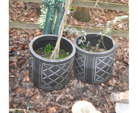 A PAIR OF MODERN BLACK PLASTIC GARDEN PLANTERS, with planting, diameter 44cm, along with a coiled hose pipe on stand, Conditi