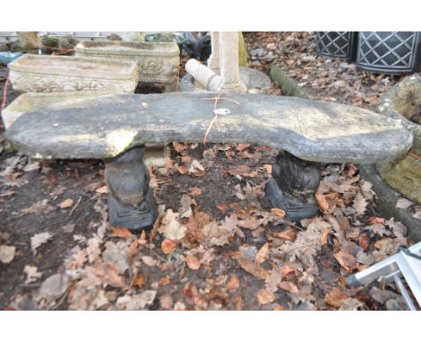 A SHAPED MODERN COMPOSITE GARDEN  BENCH with wooden plank effect top and squirrel supports length 120cm, Condition Report: ov