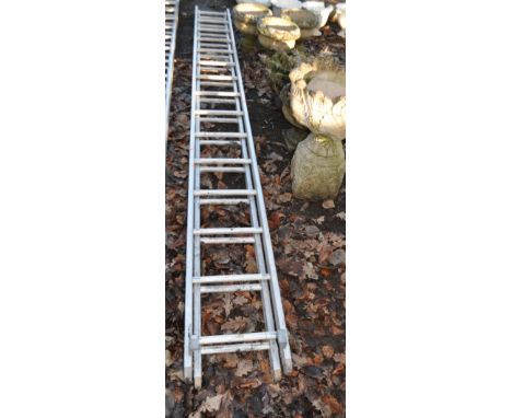 AN ALUMINIUM DOUBLE EXTENSION LADDER with fifteen rungs to each 380cm length, Condition Report: top stoppers have been change