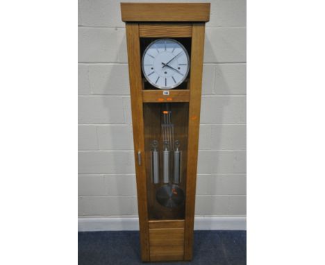 A MODERN OAK CASED CHIMING LONGCASE CLOCK, the glass door enclosing a 10.5 inch dial, depicting Roman numerals, three weights