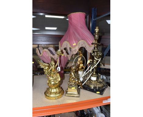 A QUANTITY OF CHERUB RELATED DECORATIVE ITEMS to include two lamps comprising a cherub figurative gilt lamp base on a black m