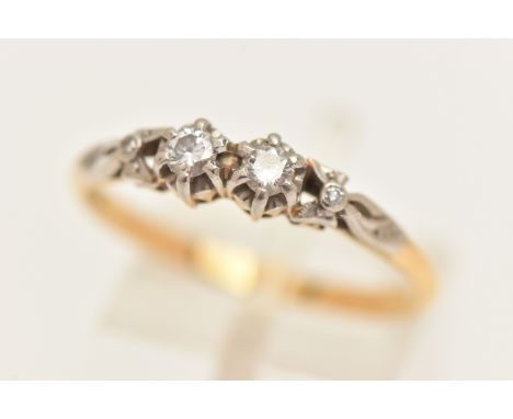 A YELLOW AND WHITE METAL DIAMOND RING, two claw set round brilliant cut diamonds, in a white metal mount, flanked with single