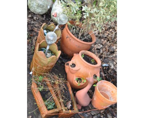 A COLLECTION OF TERRACOTTA AND TERRACOTTA COLOURED GARDEN ITEMS including a large balustered  planter (diameter at rim 46cm),
