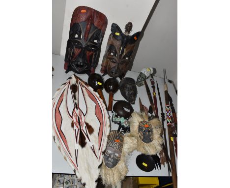 A LARGE GROUP OF AFRICAN RELATED ITEMS to include a monochrome carved wooden mask, two Kenyan 'Jambo' masks to include one wi