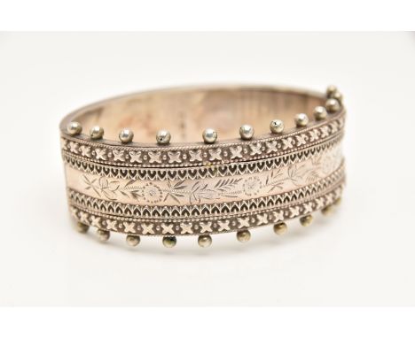 A VICTORIAN SILVER HINGED BANGLE, a wide bangle with beading and etched foliage detail, fitted with an integrated push pin cl