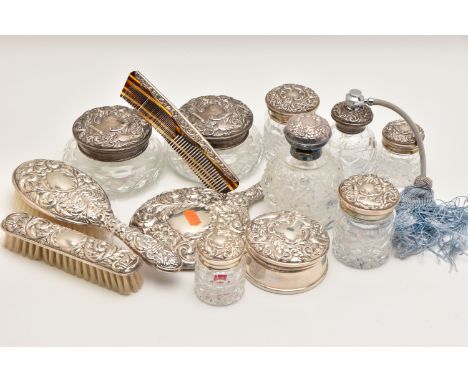 A BOX OF ASSORTED SILVER VANITY ITEMS, to include six glass jars with silver lids, a glass bottle with a silver lid, a trinke