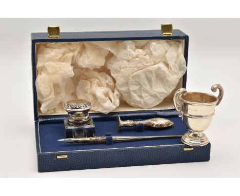 A SILVER WRITING SET AND MINATURE TROPHY, a blue rectangular form case containing a glass inkwell with silver lid, a stamp an