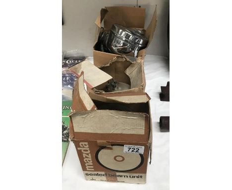 A fog light, 2 Lucas 700 seal beam lamps and spares.
