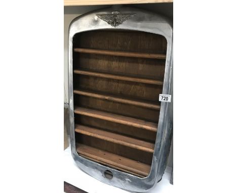 A pre war Austin radiator grill surround made in to model display shelves.
