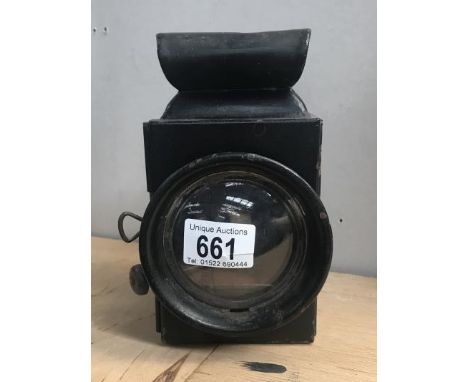 A Ford model T ton truck side light impressed with Ford logo on top.