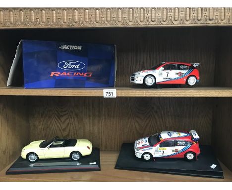 A boxed model on plinth of a Ford racing car, an unboxed model of a Ford racing car and a model of a Thunderbird show car.
