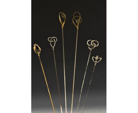 Art Nouveau hatpins to include two Birmingham silver swirl finial; a yellow metal pin, amethyst coloured glass set; others si
