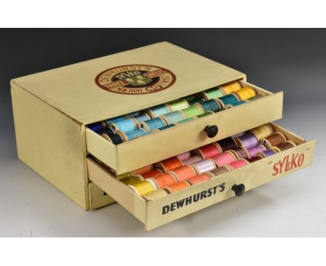 A Dewhurst's Sylko three drawer cabinet with quantity of vintage and other bobbins of thread