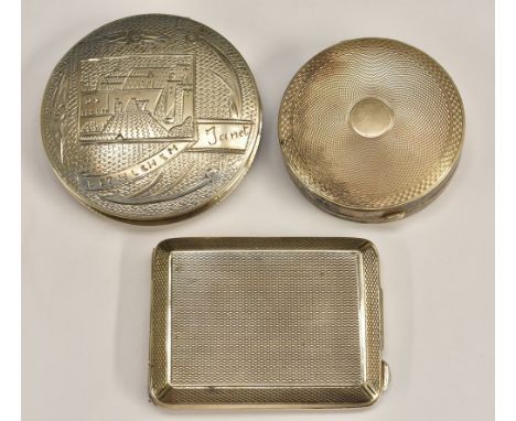 A silver compact, engine turned, Birmingham 1930; a silver match book holder, engine turned, London 1922; a white metal compa