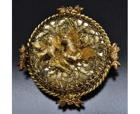 A retro Reuge Ste Croix clockwork music box brooch, gilt metal body with two Cherubs, upon scrolled panel ground, surrounded 