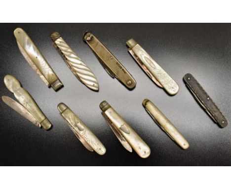A late 19th Century mother of pearl and silver fruit knife; a silver twin bladed fruit knife; others similar (9)
