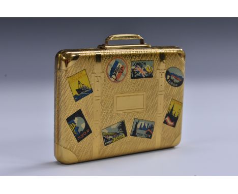 A Kigu novelty powder compact as a suitcase bearing traveller's labels, soft cloth cover