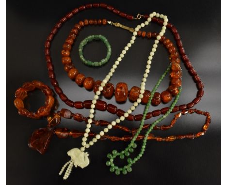 Jewellery - a cherry amber graduated tubular barrel bead necklace; others copal, etc;   a jade necklace; another stone, bangl