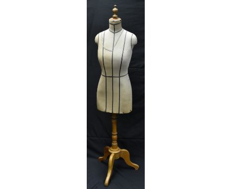 An early 20th century lady's mannequin, The French Bust Co Ltd, Wigmore street, London, tripod feet, turned finial, original 