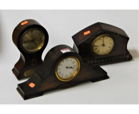 An Edwardian mahogany and box wood strung balloon shaped mantel clock having a silvered dial with Arabic numerals and 8-day m