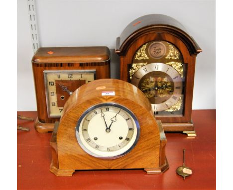 A 1940s walnut cased mantel clock having a silvered chapter ring with Roman numerals and eight day movement, together with a 