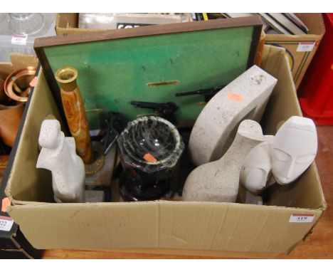 A box of miscellaneous items to include a carved serpentine model of a church font, onyx candle stick etc