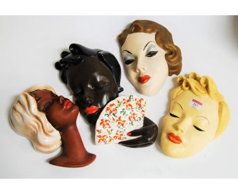 A West German pottery wall mask of a lady in the Goldscheider style, impressed 3682 verso, height 26cm; together with three A